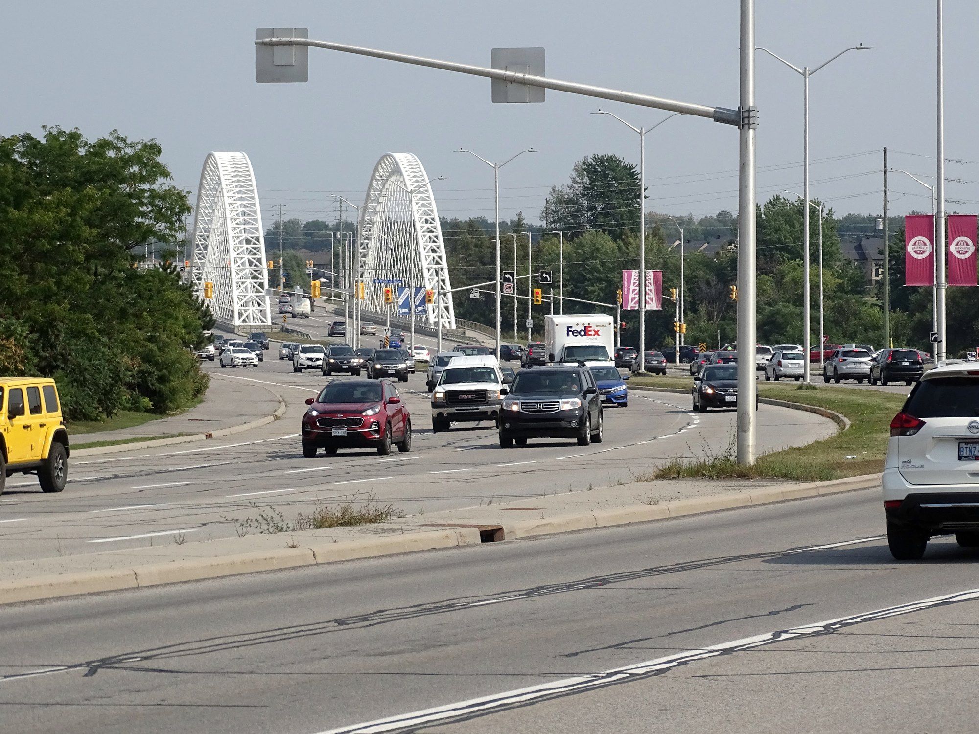 Strandherd Drive in Barrhaven with the arches of the Vimy Memorial Bridge ahead