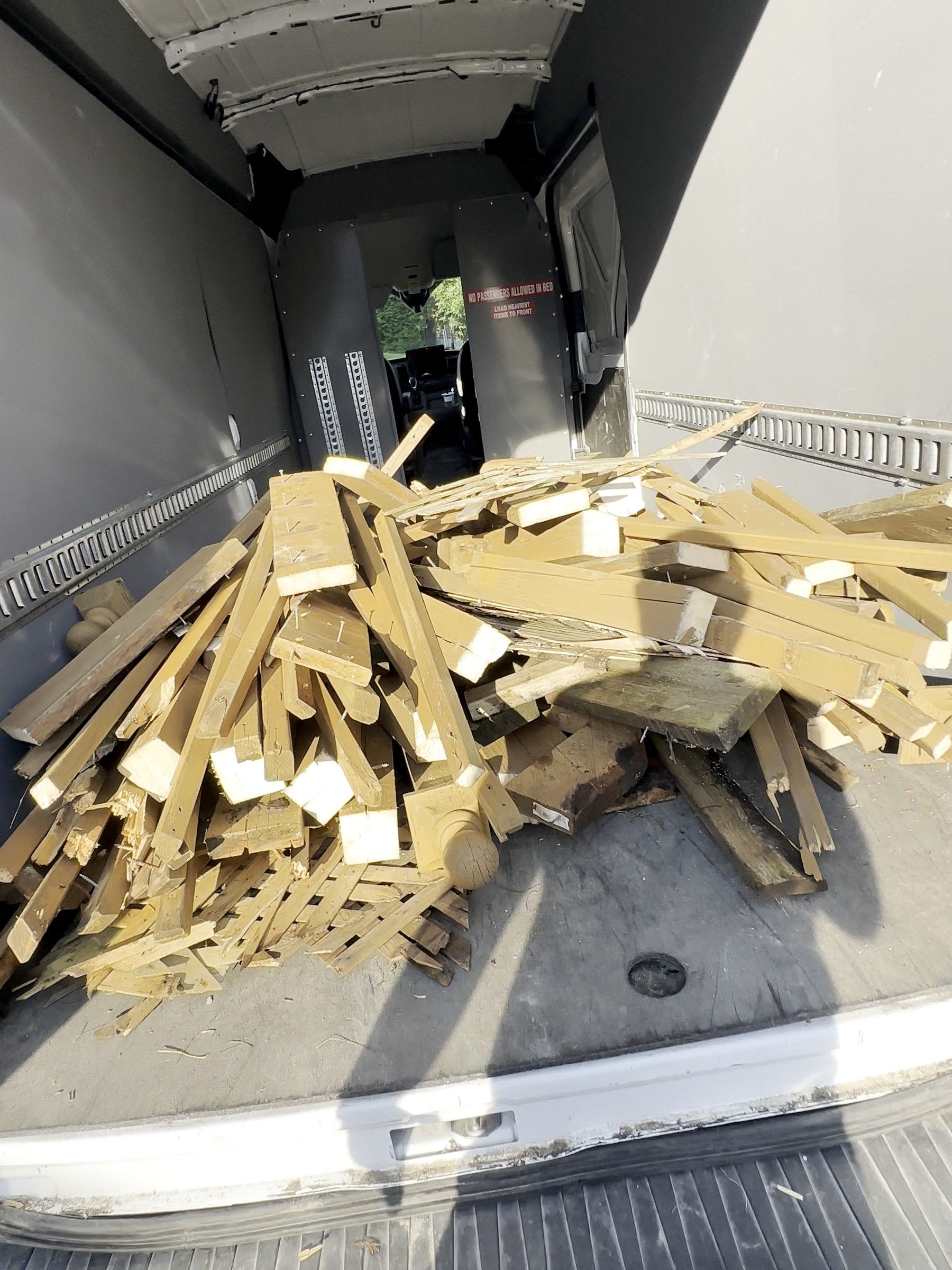 Old deck lumber loaded into the Korvex van for removal