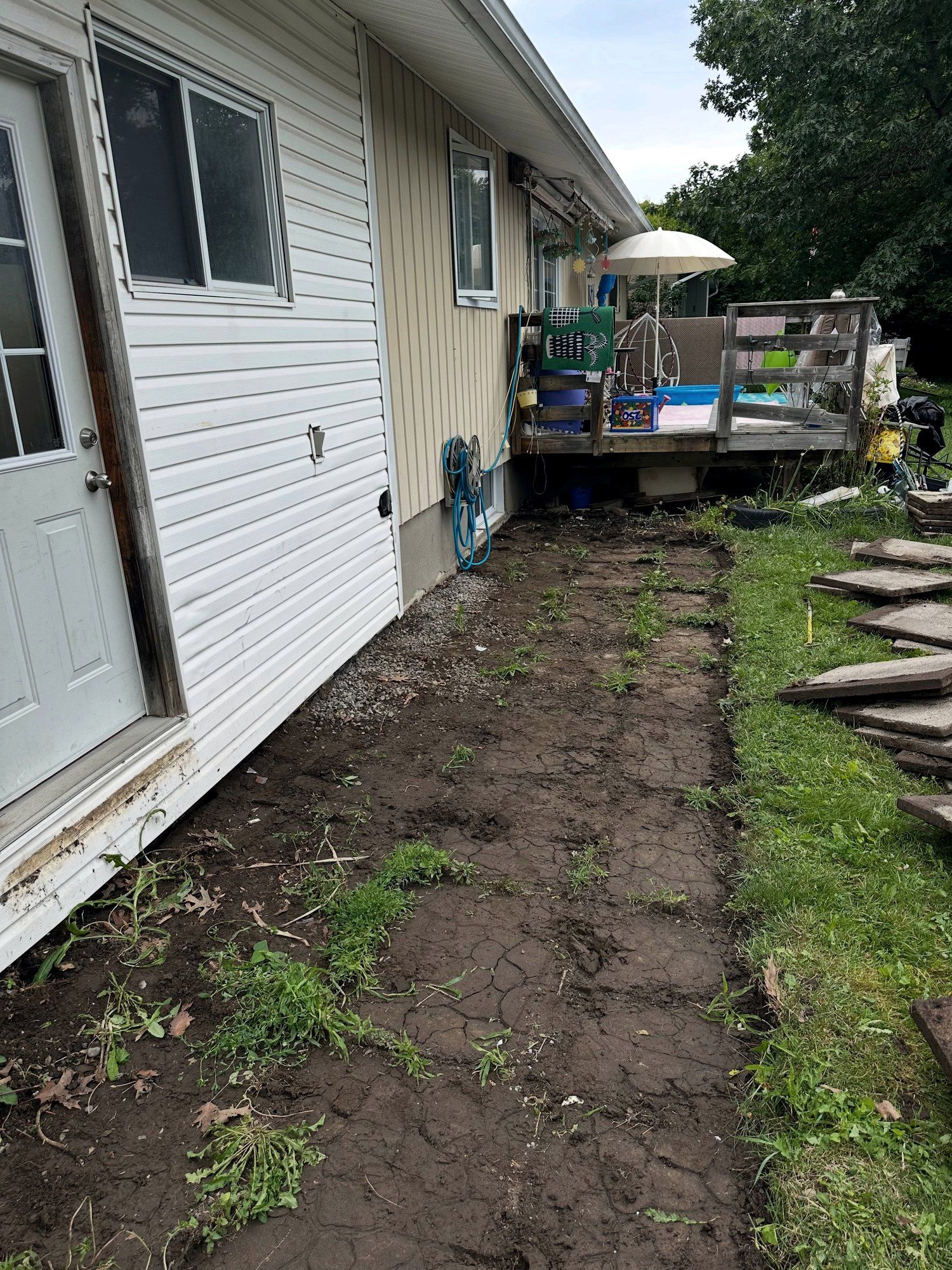 Side yard dug down along the house wall after the old slabs and topsoil came out