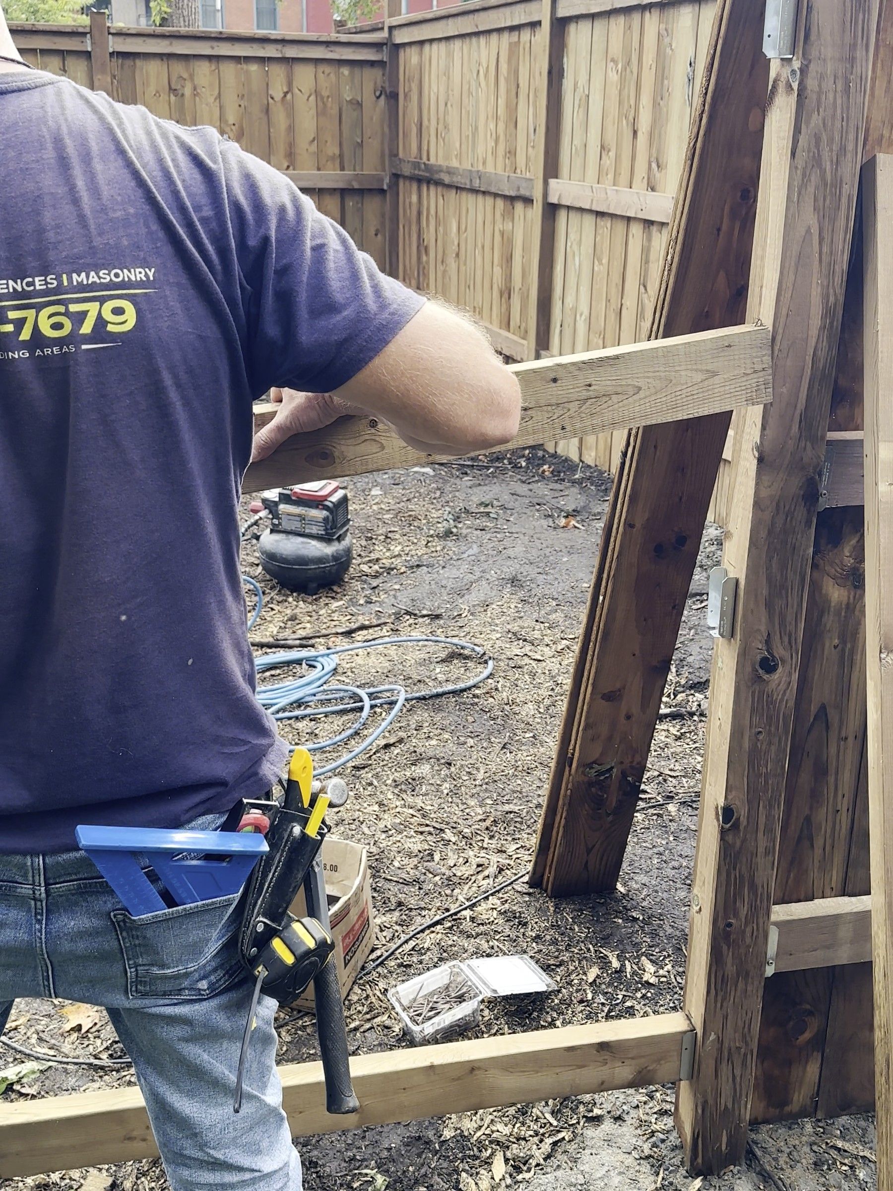 Korvex crew member fastening a rail between new fence posts