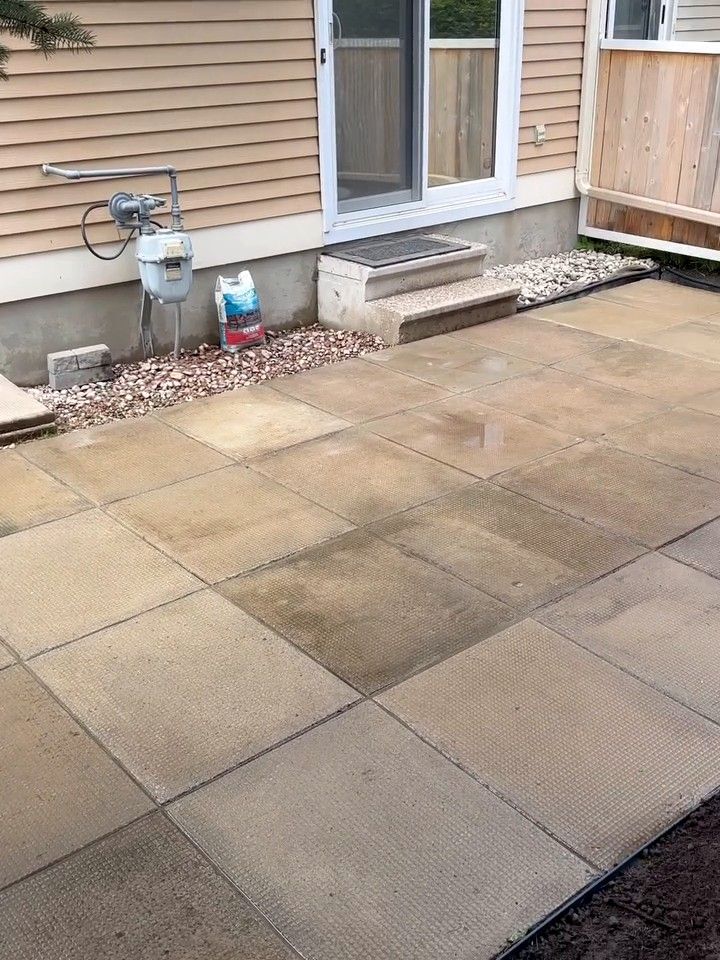 Finished concrete slab patio along the back of a house
