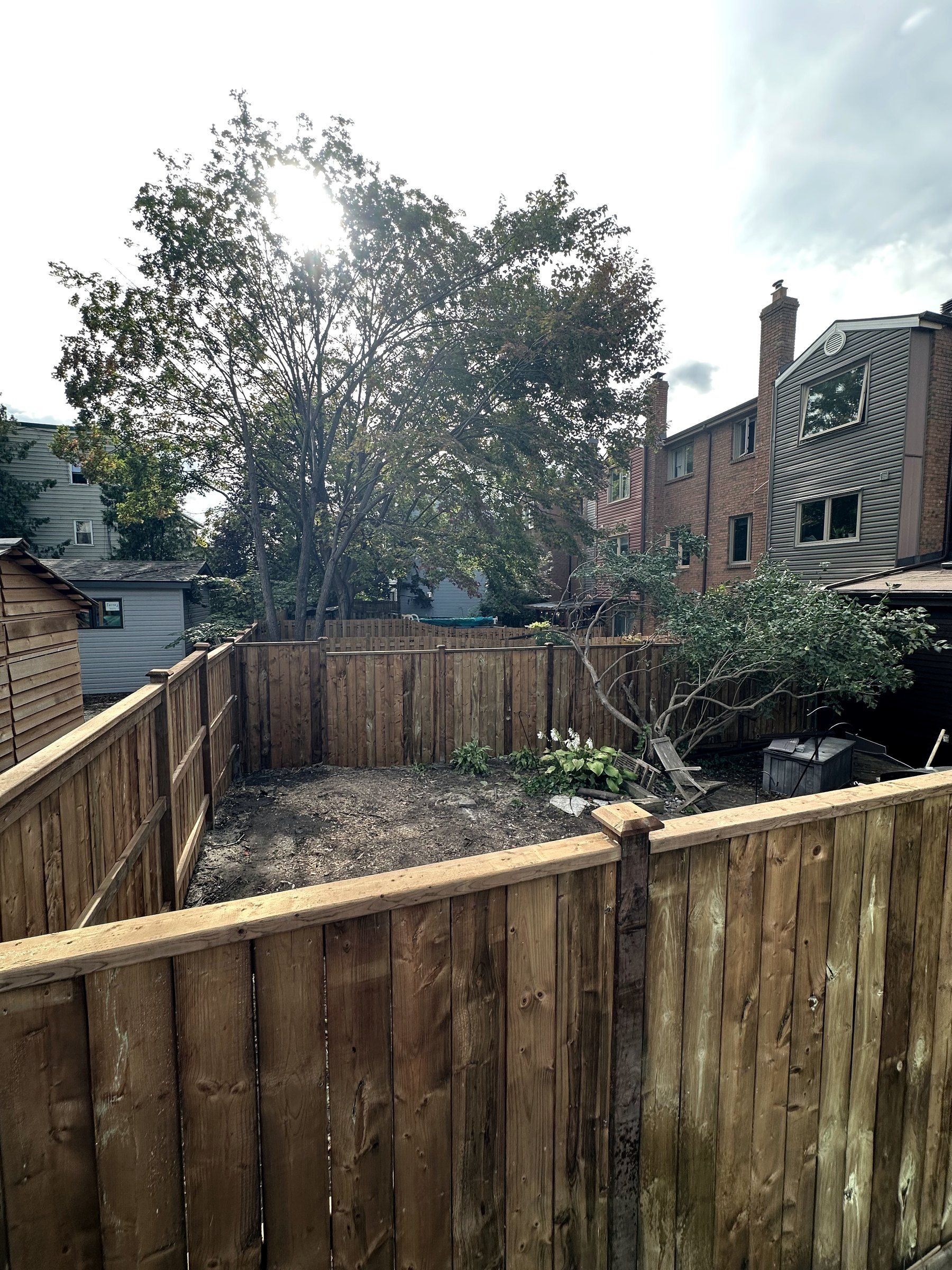 New board-on-board wood fence around a townhouse backyard in Ottawa, built by Korvex