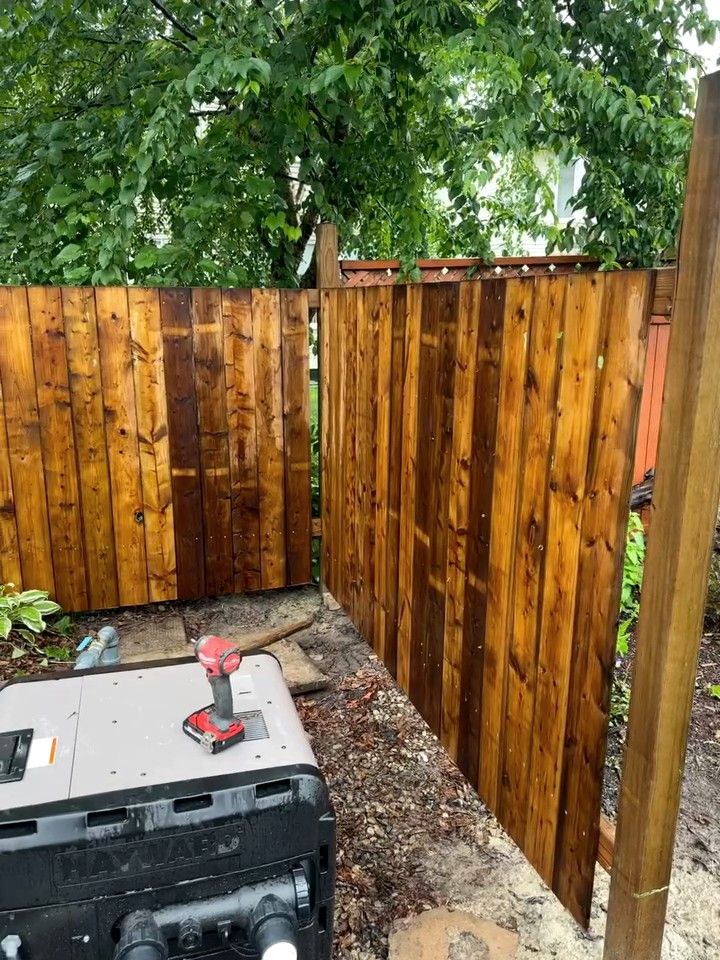 Wood gate hung in a new privacy fence line