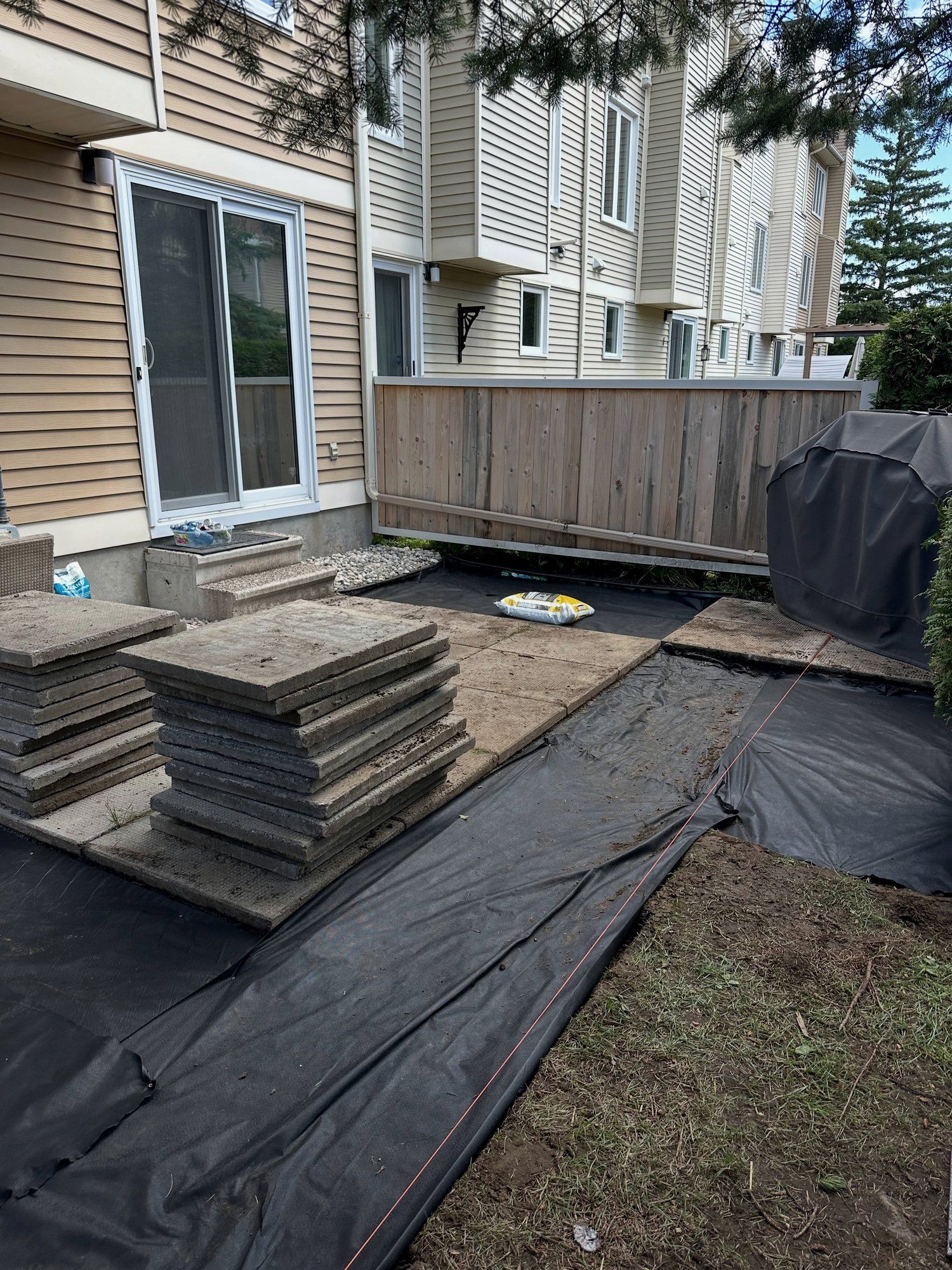 Patio slabs being laid again on a new base and fabric