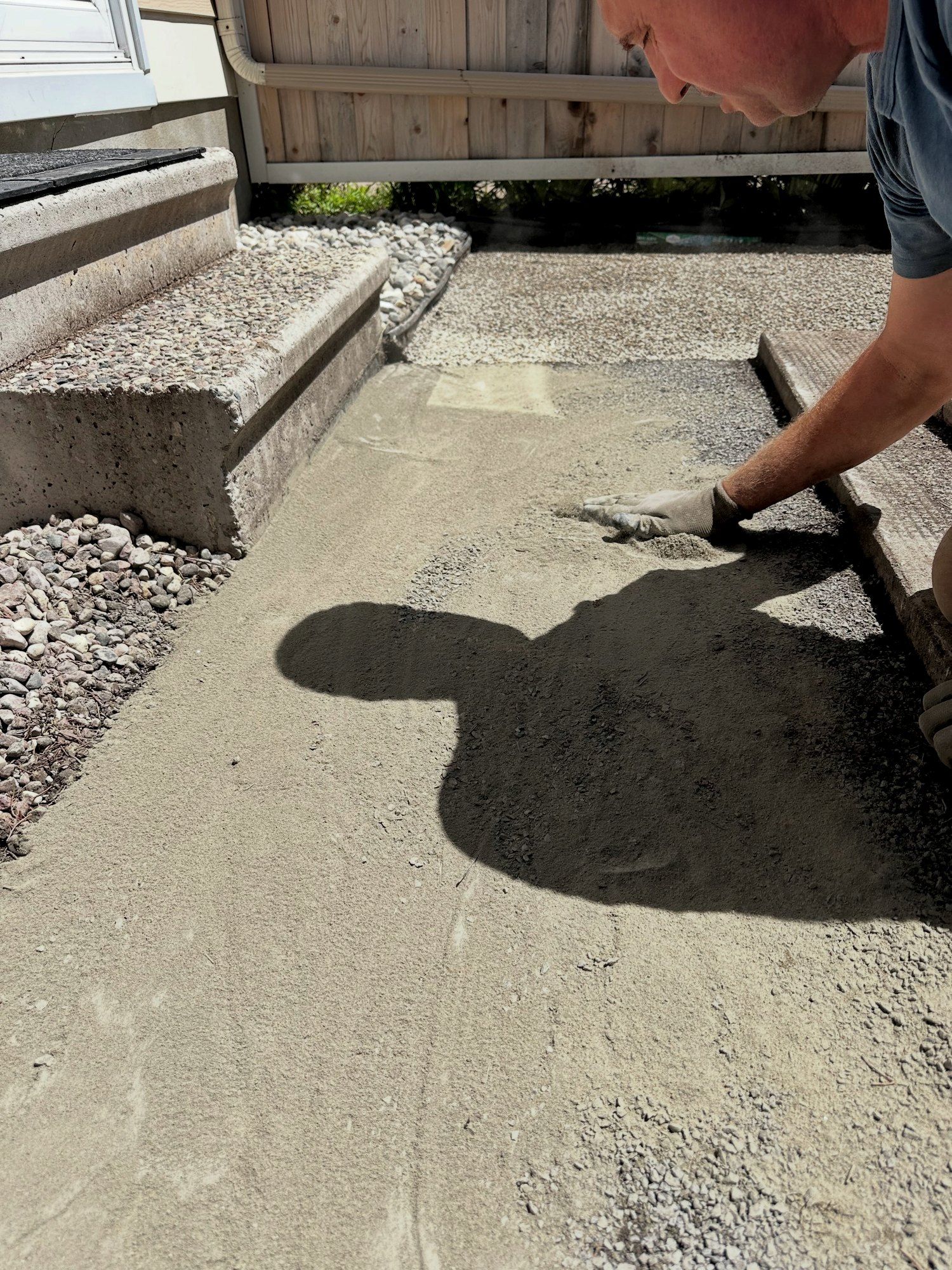 Korvex crew screeding the bedding layer flat before laying patio slabs