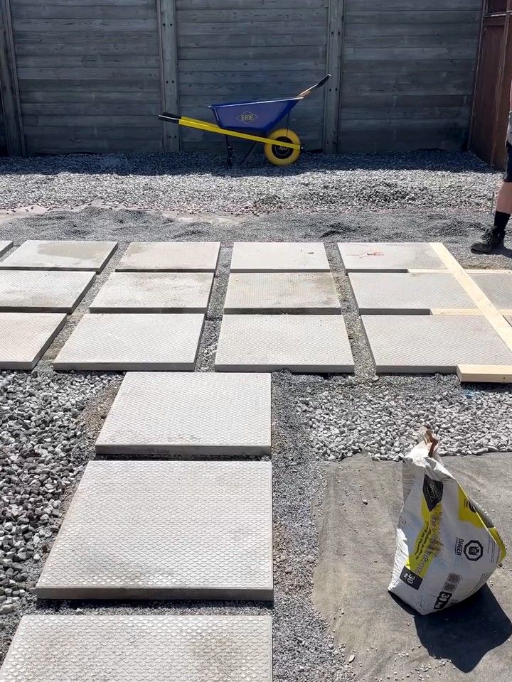 Patio slabs laid out over the gravel