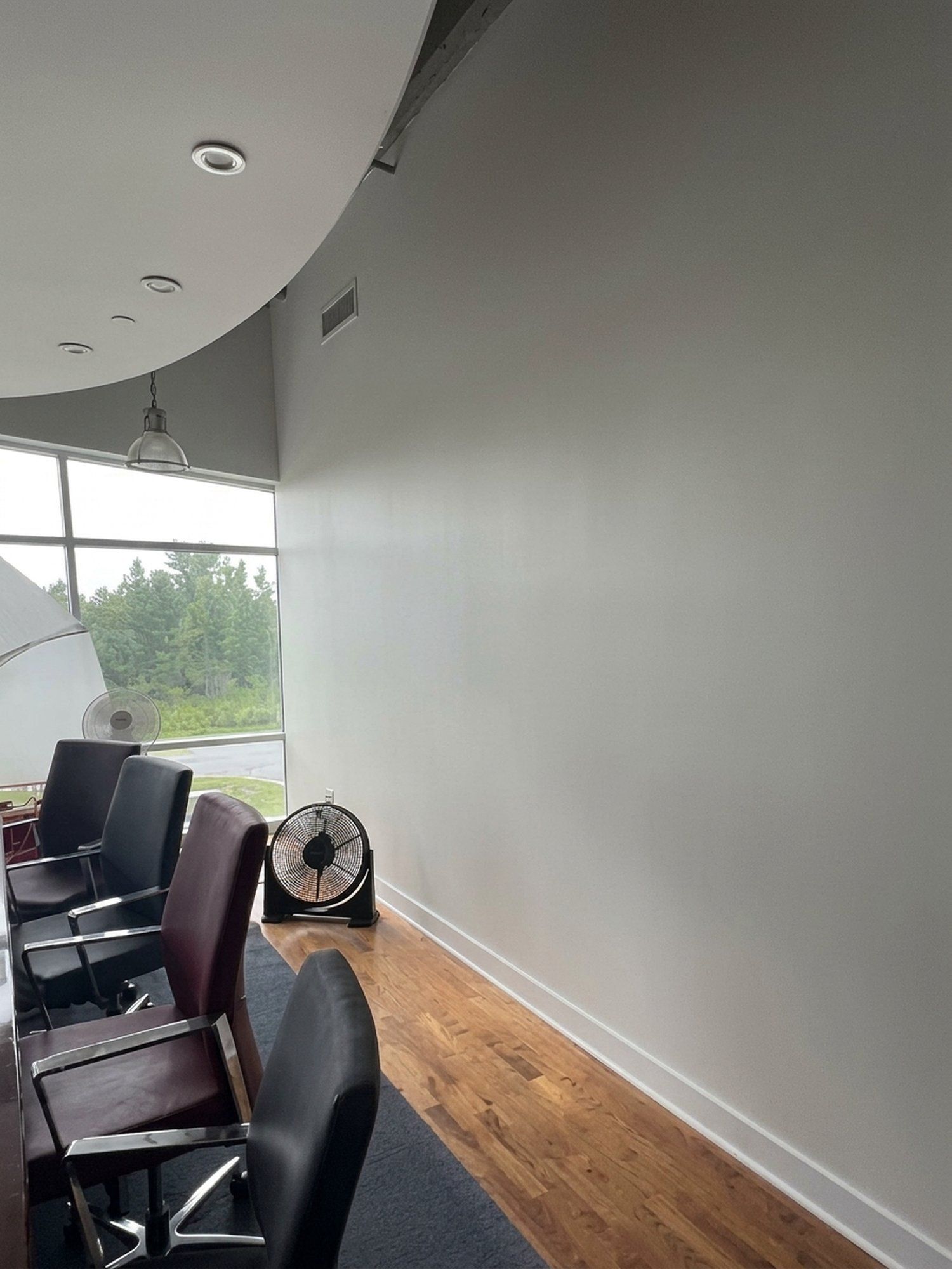 Refinished boardroom wall beside a row of windows